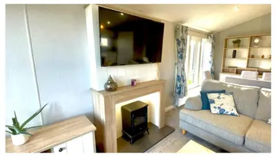 a living room with a couch and a fireplace at The Retreat Lodge in Newquay