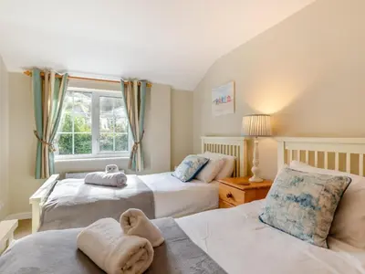 a bedroom with two beds and a window at 3 Bed in St. Austell oc-95623 in Gorran Haven