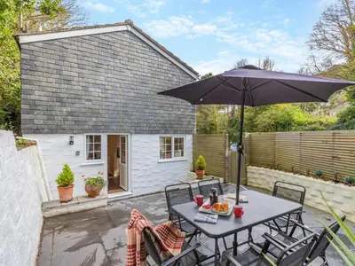 a patio with a table and an umbrella at 3 Bed in St. Austell oc-95623 in Gorran Haven