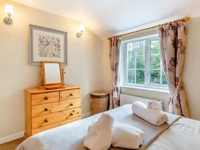 a bedroom with a bed and a window at 3 Bed in St. Austell oc-95623 in Gorran Haven