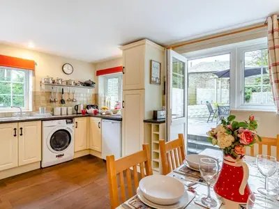 a kitchen and dining room with a table and chairs at 3 Bed in St. Austell oc-95623 in Gorran Haven