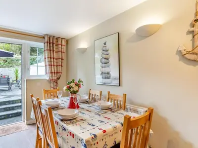 a dining room with a table and chairs at 3 Bed in St. Austell oc-95623 in Gorran Haven