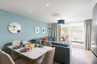 a living room with a table and a couch at 3 St Nicholas Court in St Ives