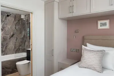 a bedroom with a bed and a shower at 3 St Nicholas Court in St Ives