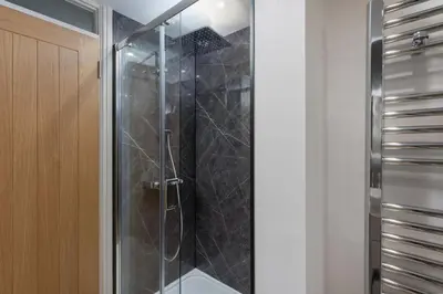 a shower with a glass door in a bathroom at 3 St Nicholas Court in St Ives
