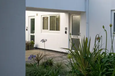 a front door of a white house with plants at 3 St Nicholas Court in St Ives