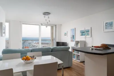 a living room with a couch and a table at Four Seawinds in St Ives