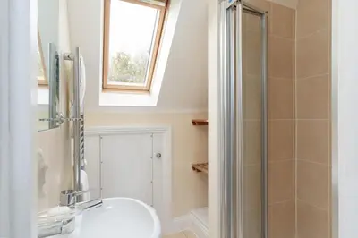 a bathroom with a sink and a shower at The Oystercatcher in St Ives