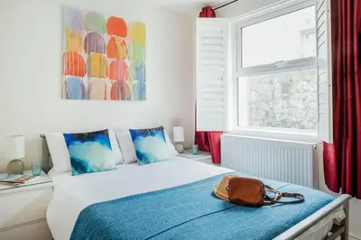 a bedroom with a bed with a purse on it at 10 Fernlea Court in St Ives
