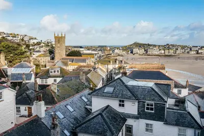 a view of a town with a beach and houses at 10 Fernlea Court in St Ives