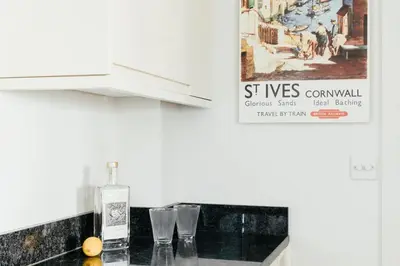 a bottle of whiskey on a counter in a kitchen at 10 Sunday School Court in St Ives