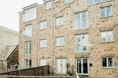 a large brick building with white windows at 10 Sunday School Court in St Ives