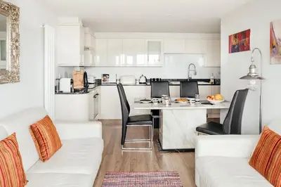 a kitchen and living room with a table and chairs at 10 Sunday School Court in St Ives