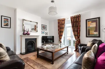 a living room with a coffee table and a fireplace at 3 The Elms in St Ives