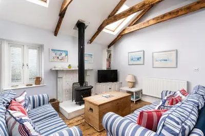 a living room with two couches and a wood stove at Ponckle's Place in St Ives