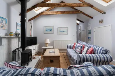 a living room with two couches and a fireplace at Ponckle's Place in St Ives