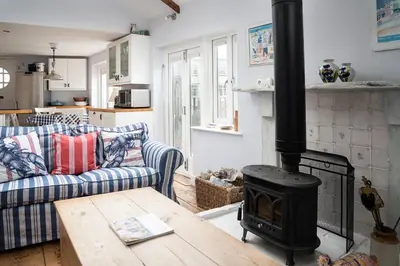 a living room with a fireplace and a couch at Ponckle's Place in St Ives