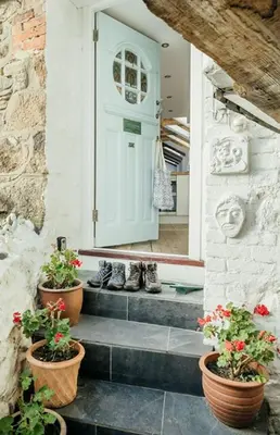 a pair of shoes sitting on the steps of a house at Ponckle's Place in St Ives