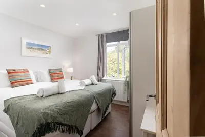 a bedroom with a bed and a window at 1 The Elms in St Ives