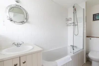 a bathroom with a sink and a toilet and a mirror at 22 Piazza in St Ives