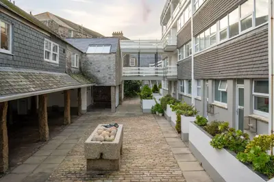 an internal courtyard of a building with plants at 22 Piazza in St Ives