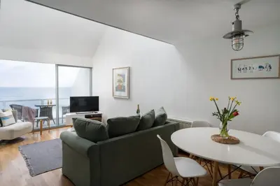 a living room with a couch and a table at 22 Piazza in St Ives