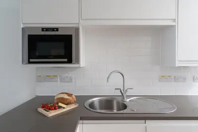 a kitchen with a sink and a microwave at 22 Piazza in St Ives