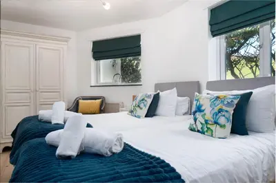 a bedroom with two beds with towels on them at The Beach in Praa Sands