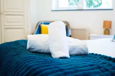 a pile of towels sitting on top of a bed at The Beach in Praa Sands