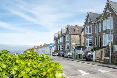 a street with a row of houses and cars parked at Skylar in St Ives