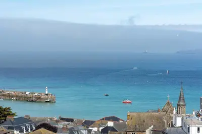 a view of a city and the ocean with a town at Skylar in St Ives