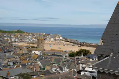 a view of a town with a beach and the ocean at Skylar in St Ives