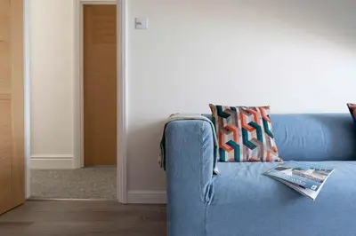 a blue couch sitting in a living room at Skylar in St Ives