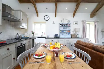 a kitchen with a wooden table with fruit on it at Upper Trowan in St Ives