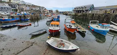 a group of boats are docked in a harbor at Harbour Tavern Penthouse in Mevagissey
