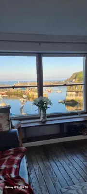 a large window with a view of a body of water at Harbour Tavern Penthouse in Mevagissey