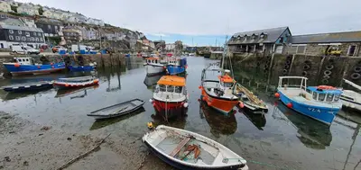 a group of boats are docked in a harbor at Harbour Tavern Penthouse in Mevagissey