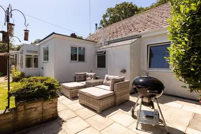 a patio with a grill and a couch and a grill at Good Life on the Coast in Falmouth