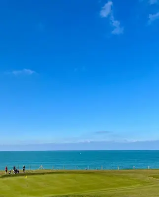 a group of people riding horses on a field near the ocean at Pentire Point - Coastal Penthouse, Beaches, River & Restaurants All Within Short Walk in Newquay