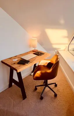 a wooden desk with a chair and a lamp at Pentire Point - Coastal Penthouse, Beaches, River & Restaurants All Within Short Walk in Newquay