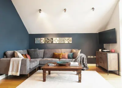 a living room with a couch and a table at 6 Porth Sands Newquay Cornwall Luxury with Sea Views in Newquay