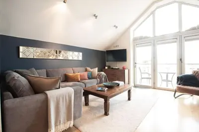 a living room with a couch and a coffee table at 6 Porth Sands Newquay Cornwall Luxury with Sea Views in Newquay