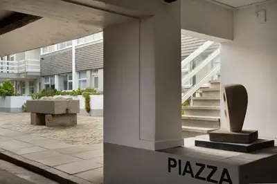 a building with stairs and a bench in a courtyard at 24 Piazza in St Ives