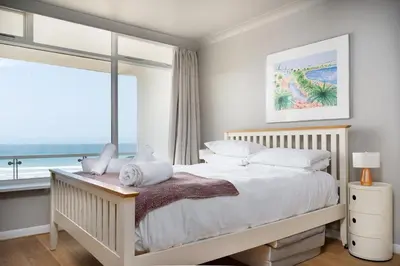 a bedroom with a large bed with a large window at 11 Barnaloft in St Ives