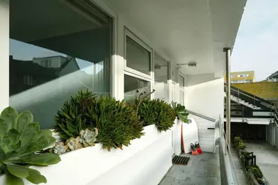 a balcony with potted plants on a building at 11 Barnaloft in St Ives