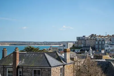 a view of a city with houses and the water at 8 Sunday School Court in St Ives