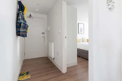 a room with a bedroom with a bed and a door at 8 Sunday School Court in St Ives