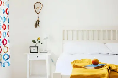 a bedroom with a bed with a table and an apple on a blanket at Bodeeve in Penzance