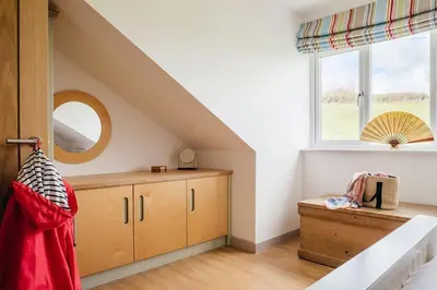 a attic bedroom with a bed and a window at Bodeeve in Penzance