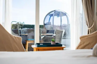 a room with a bed and a table and a mirror at The Cove in Praa Sands